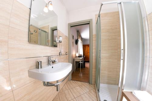 a bathroom with a sink and a shower at Hotel Volta in Padova
