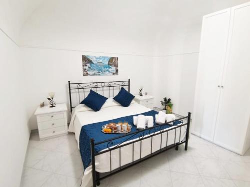 a bedroom with a bed with a tray of food on it at La Rondine B&B in Massa Lubrense