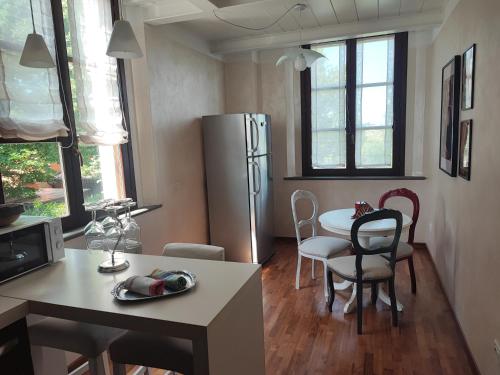 a kitchen with a refrigerator and a table and chairs at Appartamento in Villa Aulla in Pontedera