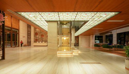 a lobby of a building with a glass ceiling at DongHu Resort Hotel in Sihanoukville