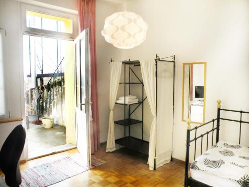 a bedroom with a bed and a chandelier at Guest house - Maison d'hôtes "Relais des Saars" in Neuchâtel