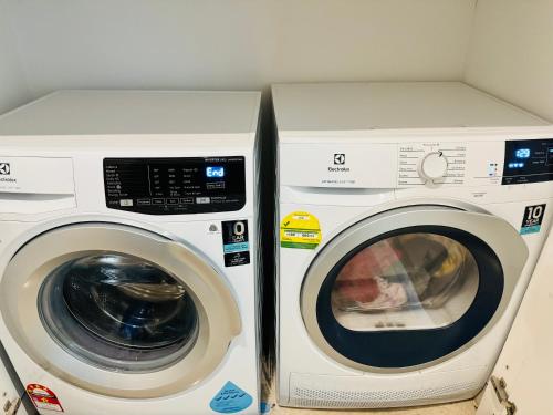 a washing machine and a dryer in a room at LUCENTIA RESIDENCE By LALAPORT in Kuala Lumpur