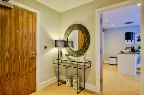 a room with a mirror and a table with a lamp at Lambert House in Harrogate