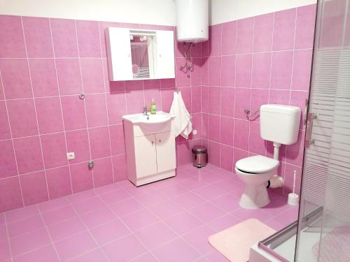 a pink bathroom with a toilet and a sink at TRI KRALJA - THREE KINGS Apartments in the center with private parking in Imotski