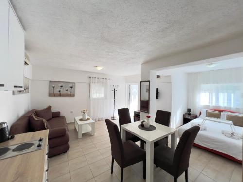 a bedroom and living room with a bed and a table at Apartments Pribilovic in Budva