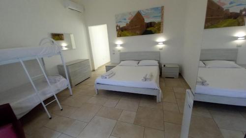 two beds in a room with two bunk beds at B&B Bonomi in Torre Lapillo