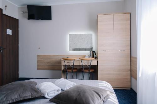 a bedroom with a bed and a small desk at DW Turysta in Licheń Stary
