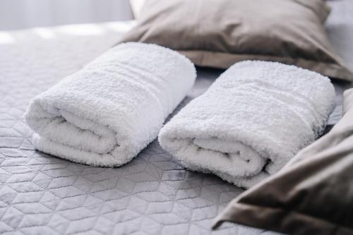 a white towel folded towels on a bed at DW Turysta in Licheń Stary