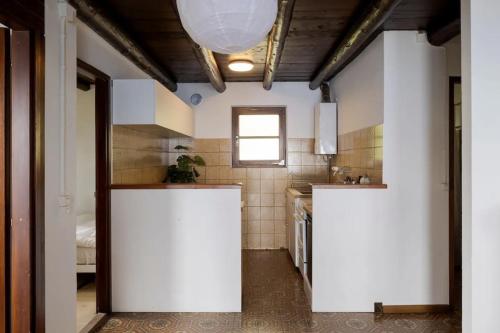 a kitchen with white walls and a white counter top at Oasi di pace vista lago-Cardada-Locarno in Orselina