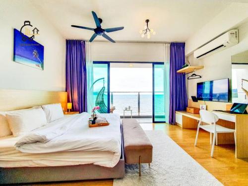 a bedroom with a large bed and a desk with a laptop at 1 min to Seaview & Sunrise Heart of Kuantan in Kuantan