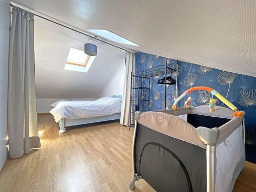 a childs room with a crib and a bedroom at Maison de ville à Berck Plage, terrasse et garage, proche plage et commerces - FR-1-646-65 in Berck-sur-Mer