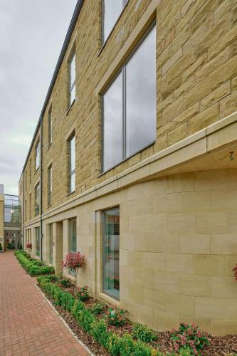 a brick building with windows on the side of it at Lambert House in Harrogate