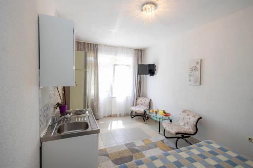 a kitchen with a sink and a table at Studio apartment Kasalo in Kaštela