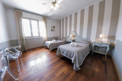 a bedroom with two beds and a window at Hotel Volta in Padova