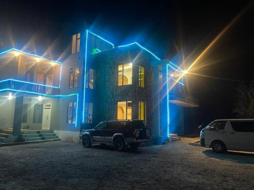 a car parked in front of a house at night at Sarfaranga Residency in Skardu