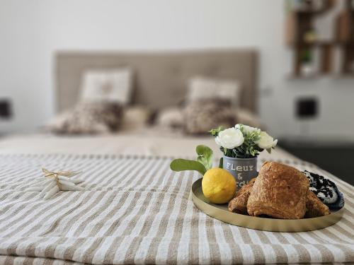 a plate of food on top of a bed at Grey House 4 100mt dal mare in Tortoreto Lido