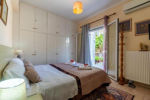 a bedroom with a bed and a window at Doris House by GuestCorfu in Corfu Town