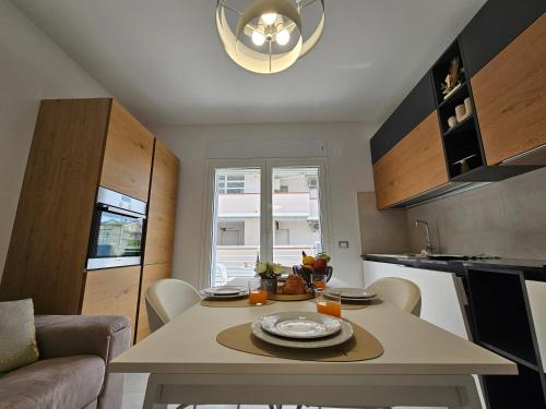 a small kitchen with a table in a room at Grey House 4 100mt dal mare in Tortoreto Lido