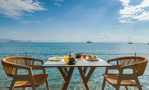 a table with a plate of food on top of the ocean at Kos Aktis Art Hotel in Kos Town
