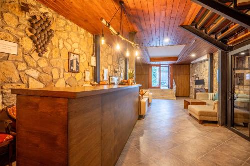 a lobby with a bar in a stone wall at Armagrandi Hotel Bozcaada-Special Category in Bozcaada