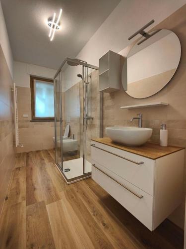a bathroom with a sink and a glass shower at Casa Bramardi in San Defedente di Cervasca