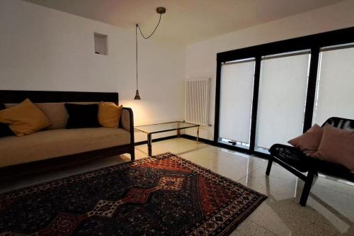 a living room with a couch and a table at Dolomiti loft in Pieve di Cadore