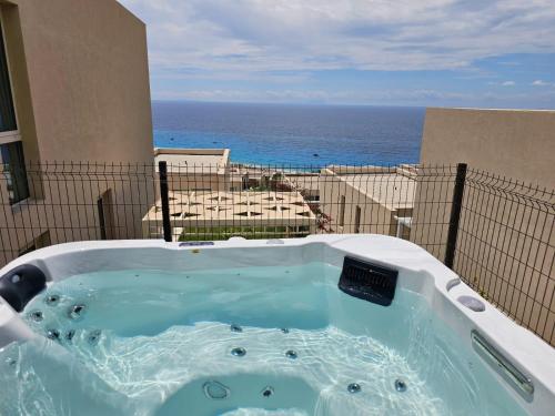 a jacuzzi tub with a view of the ocean at Palase Jacuzzi apartment 157-D GC in Llogara