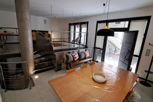 a living room with a wooden table in a room at Dolomiti loft in Pieve di Cadore