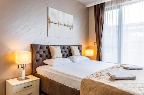 a bedroom with a large bed and a window at Galeon Residence & SPA in Sunny Beach