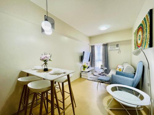 a small living room with a table and chairs at Cozy 1-Bedroom at Centrio Towers beside Ayala Mall in Cagayan de Oro