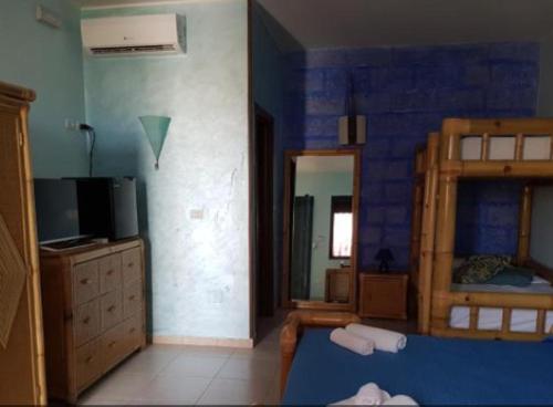 a room with a bedroom with a bed and a mirror at B&b Fa.ro.mi in Torre Lapillo