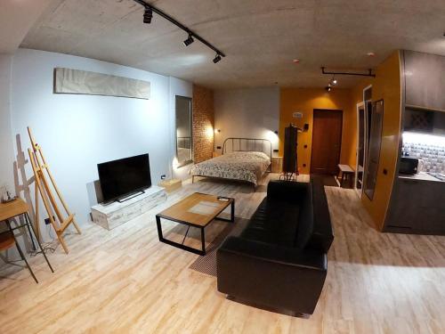 a living room with a couch and a bed at L1apartment in Kyiv