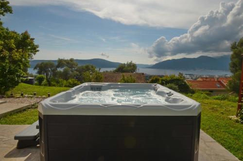 a hot tub sitting on top of a field at Boka View by Roši in Tivat