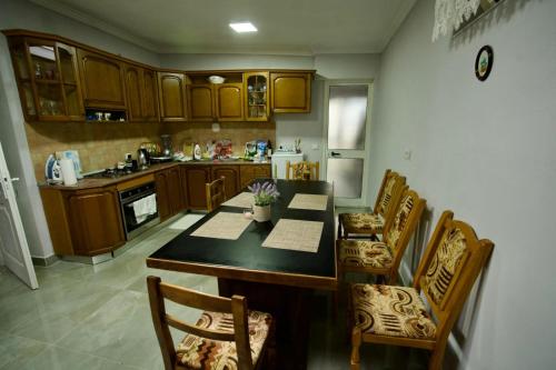 a kitchen with a table and chairs and a counter top at Garden Villa Guni in Krujë