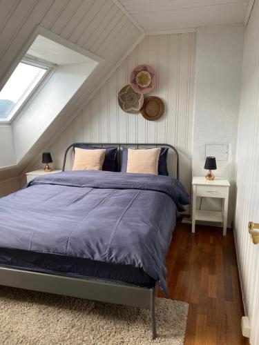 a bedroom with a bed in a attic at Panorama Apartment with 360 view of the city Ålesund in Ålesund
