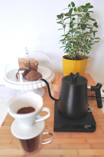 a coffee pot and a cup of coffee on a table at A-ma-ru-to in Amarinthos