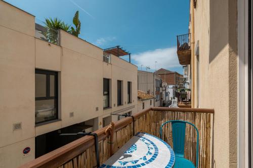 a balcony with a table and chairs on it at OASIS BEACH-CITY apartment in Montgat