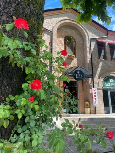 a building with red roses on the side of it at Central Hostel in Sheki