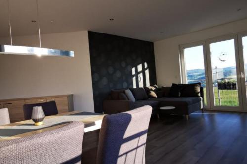 a living room with a couch and a table at Ferienwohnung BergPanorama Rhön in Gersfeld