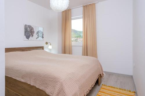a bedroom with a bed and a window at Piramida Visoko in Visoko