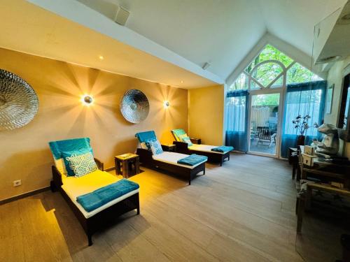 a living room with two couches and a window at Das 53°Hotel in Bad Zwischenahn