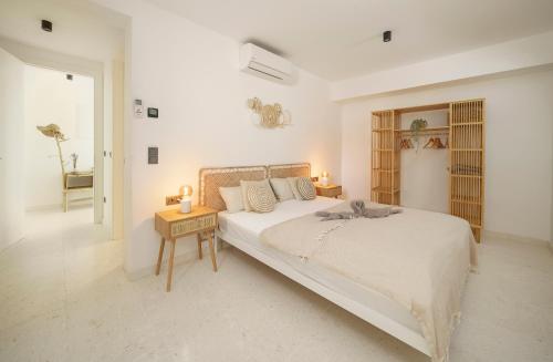 a white bedroom with a large bed and a table at modernes Apartment in Srima