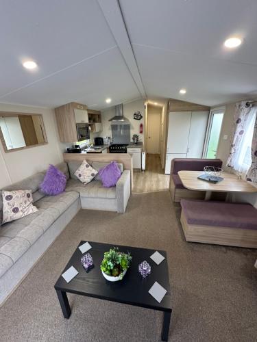 a living room with a couch and a table at 6 berth Waterside Ingoldmells R10 SANTANAVAN 7 in Ingoldmells