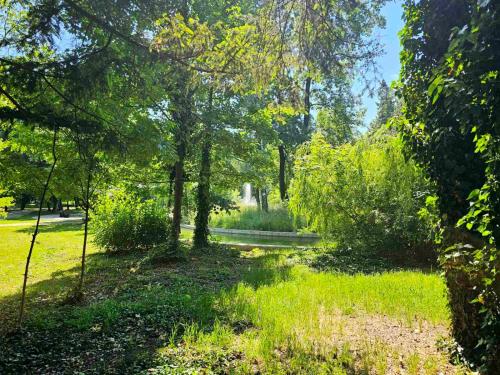 a path through a park with trees and grass at Gardenia Park Hotel in Bansko