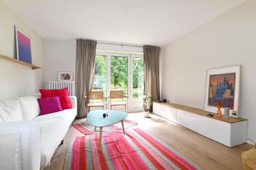 un salon avec un canapé blanc et une table dans l'établissement Confort, lumineux, proche centre, à Strasbourg