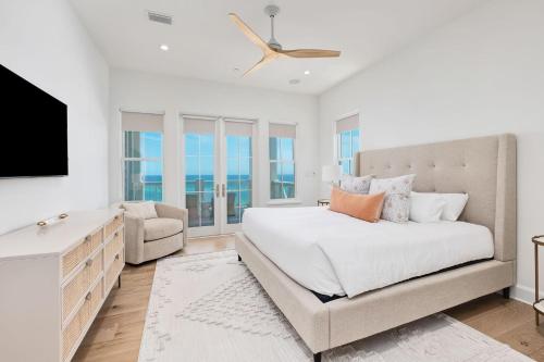 a bedroom with a bed and a tv and a couch at Del Mar in Seacrest