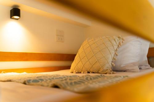 a bedroom with a bed with a pillow on it at ไชยพล โฮมสเตย์ หมู่บ้านแม่กำปอง in Ban Pok Nai