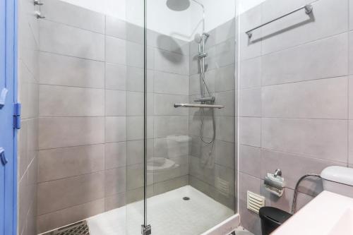 a shower with a glass door in a bathroom at Vita Portucale ! Costa Caparica Harmony in Costa da Caparica