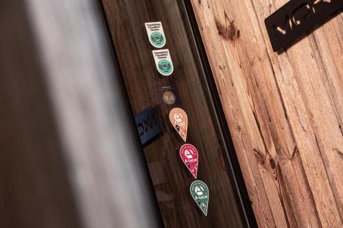 a bunch of stickers on a wooden door at Senses Violett Suites - Adults Only in Zell am See