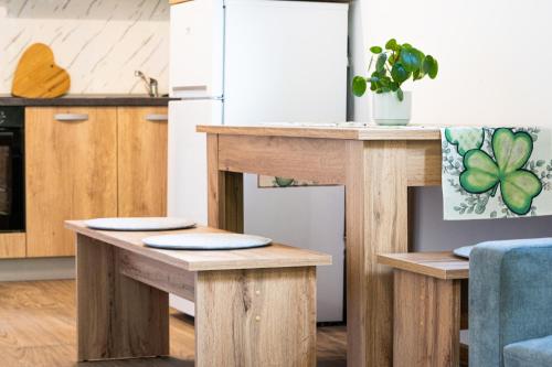 a kitchen with wooden tables and a refrigerator at apartment Sun Di Bohinj in Bohinj